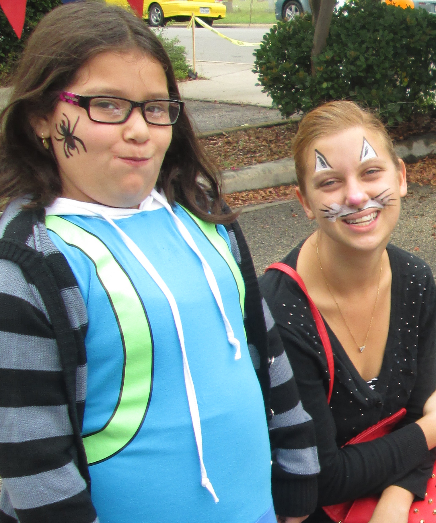 Little Sister gets spider face paint, while Big Sister opted for the cat look.